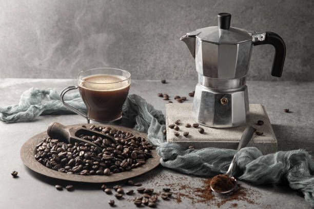 istock Hot coffee in a glass cup and coffee beans on a light background. 1347863884