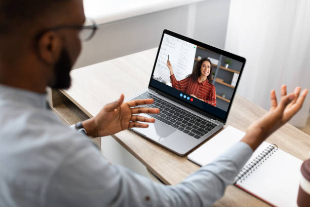 istock Millennial african american guy student studying with teacher remote, learning english language with lesson class 1347866787