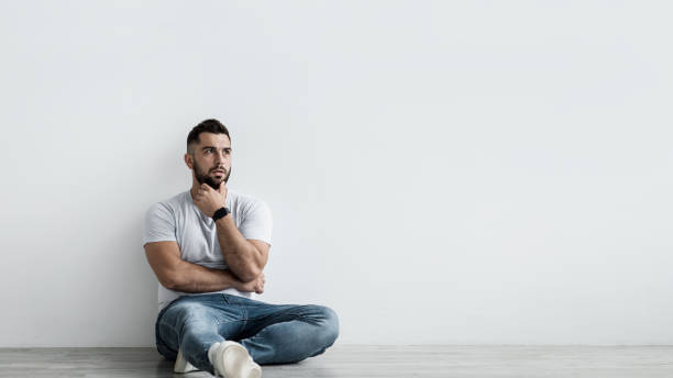 istock Sad shocked unhappy pensive handsome guy sit on floor, think and suffering from depression 1347867475