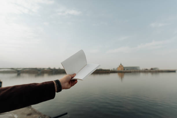 istock open book in hands on a background of water close-up 1347868823