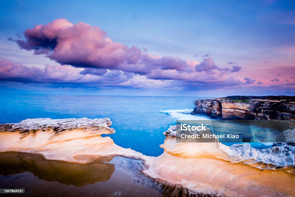 Rock Formation and Coastline against Sunset Sky Shot in Kamay Botany Bay National Park, NSW Australia Stock Photo