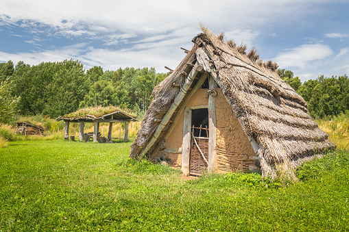 Nasavrky, Czech republic - 07 14 2021: house with straw thatched roof at in an ancient village, Celtic open air museum