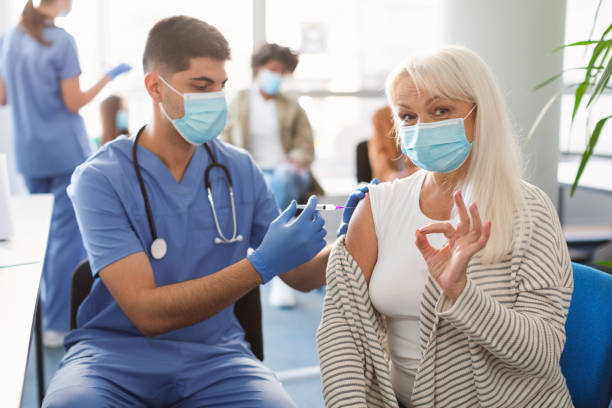 istock Vaccinated Mature Lady Gesturing Okay Sign At Clinic 1347878691