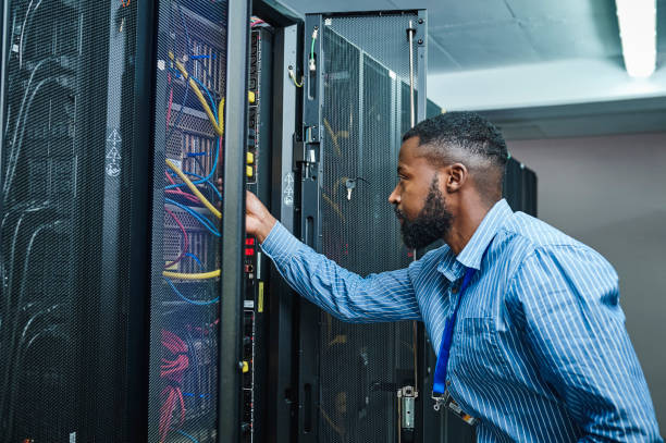 istock Shot of a young man working in a server room 1347879785