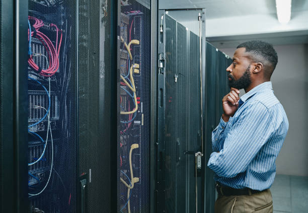 istock Shot of a young man looking thoughtful while working in a server room 1347879806