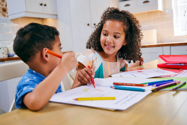 istock Shot of two young siblings completing their school work together 1347880064