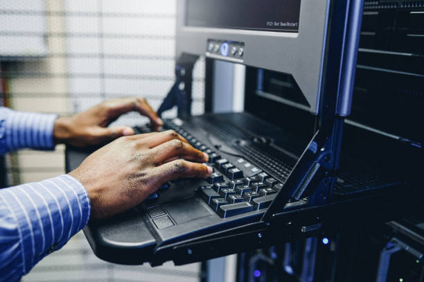 istock Closeup shot of an unrecognisable man working on a computer in a server room 1347880325