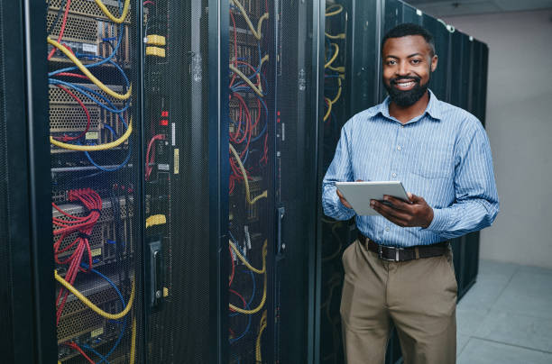 istock Portrait of a young man using a digital tablet while working in a server room 1347880330