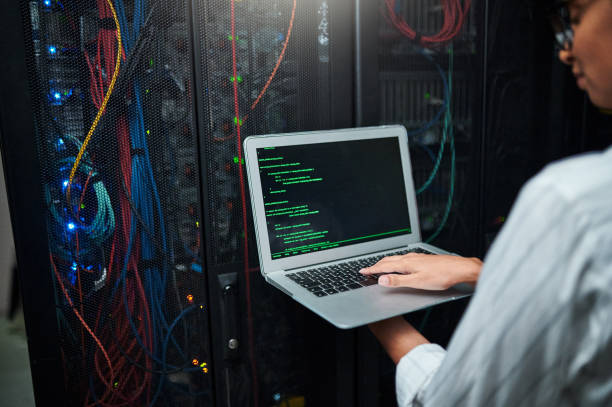istock Closeup shot of an unrecognisable woman using a laptop while working in a server room 1347880368