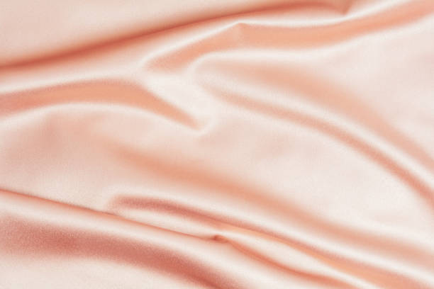 istock Textured background of pink silk or satin. 1347881430