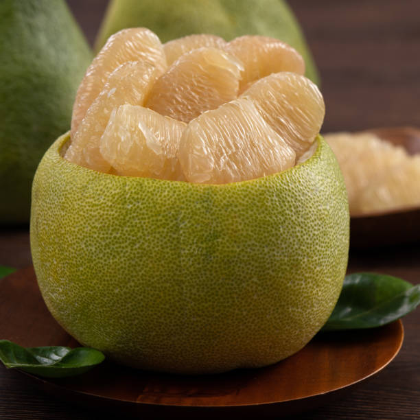 istock Fresh pomelo fruit on wooden table background. 1347883145