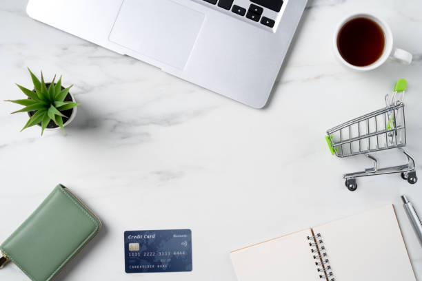 Top view of online shopping concept with credit card. Top view of online shopping concept with credit card and laptop computer isolated on office marble white table background. potted plant from above stock pictures, royalty-free photos & images