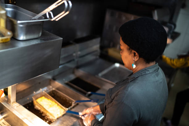 istock Mature woman cooking at a commercial kitchen 1347885122