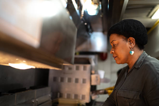 istock Mature woman cooking at a commercial kitchen 1347885132