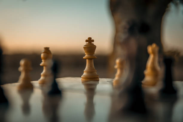 istock Chess game on the chessboard with selective focus on the king under a sunset 1347885147