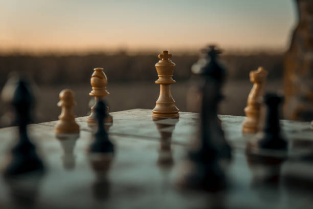 istock Chess game on the chessboard with selective focus on the king under a sunset 1347885160