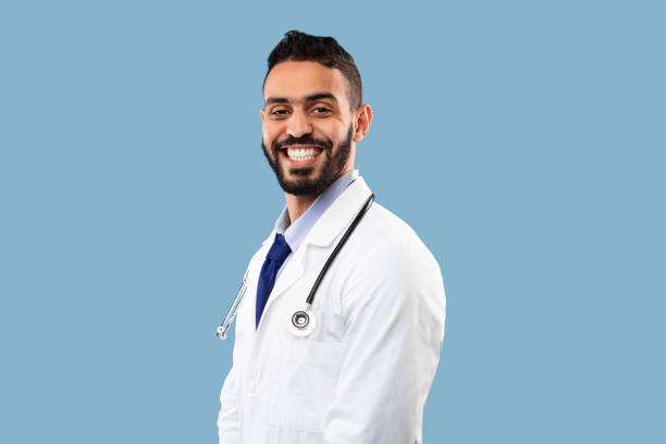 istock Headshot Of Arab Doctor Guy Wearing Uniform Posing In Studio 1347885445