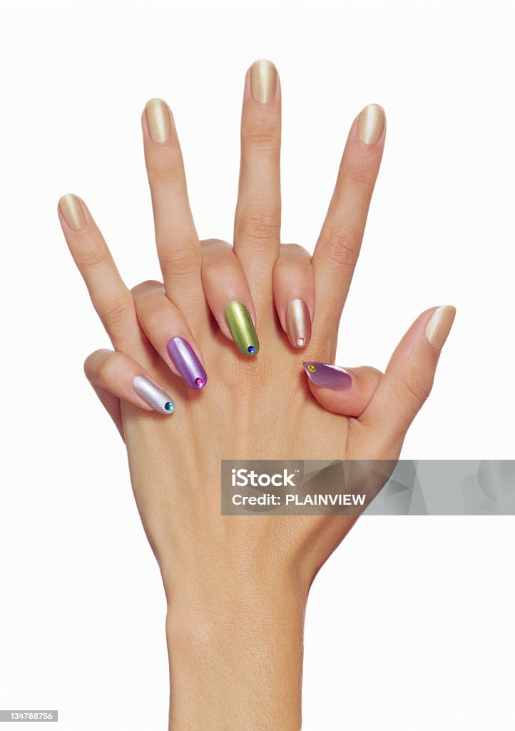 Precious Fingernail Hand with multicolor nails polish on white background Manicure Stock Photo