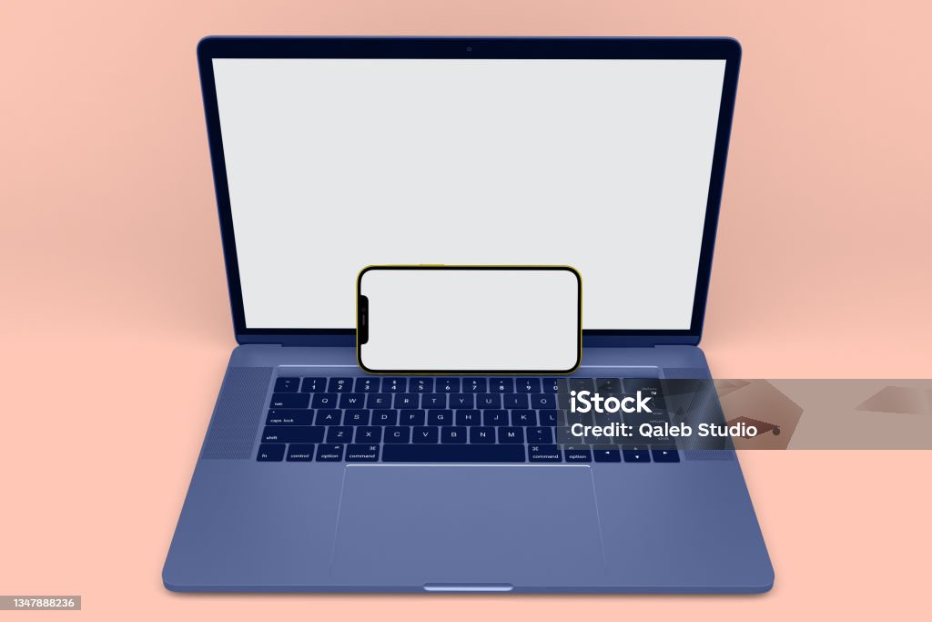 Phone 12 and Laptop Phone 12 and Laptop  With Peach Colored Background Brand Name Smart Phone Stock Photo