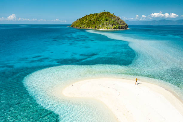 istock Happy woman standing on a perfect beach 1347888865