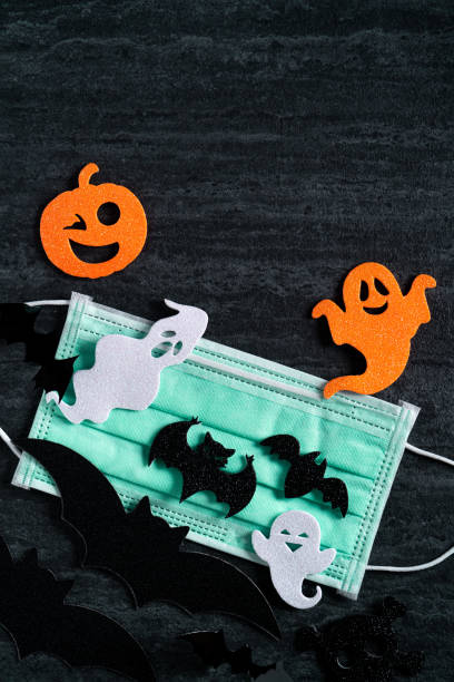 istock Top view of Halloween concept background with mask. 1347889969