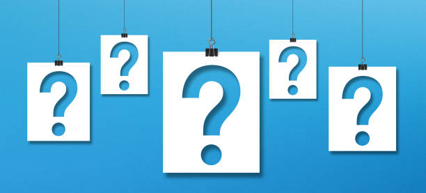 istock Question mark on paper hanging with clip on blue background 1347890003