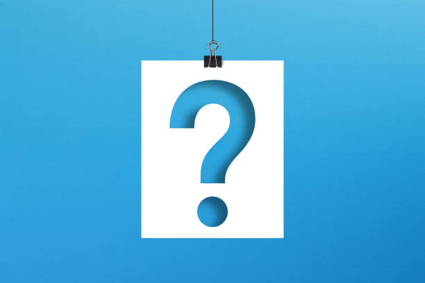 istock Question mark on paper hanging with clip on blue background 1347890004