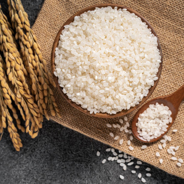 istock White rice in a bowl on dark black table background. 1347890171
