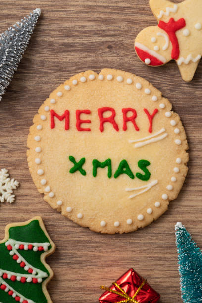 istock Decorated Christmas gingerbread cookies with decorations on wooden table background. 1347890388