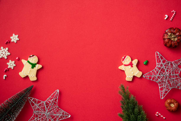 istock Decorated Christmas gingerbread cookies with decorations on red table background. 1347890564