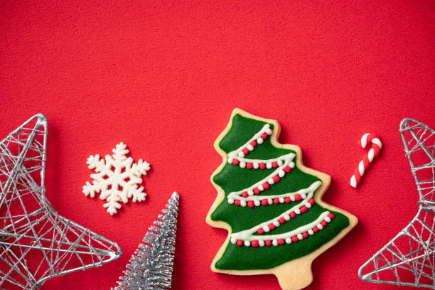 istock Decorated Christmas gingerbread cookies with decorations on red table background. 1347891304