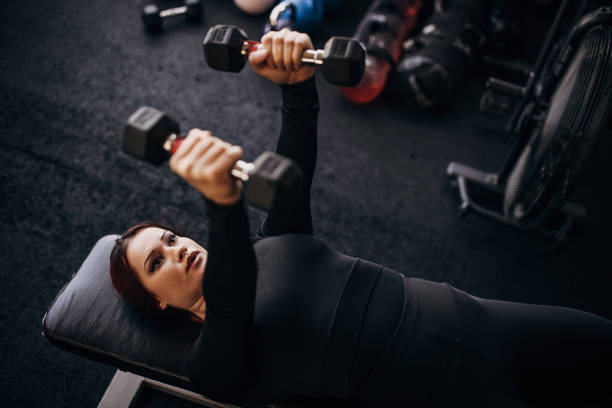 istock Young woman training with dumbbells 1347891362