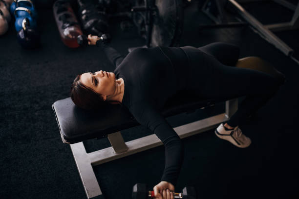 istock Fit woman training with dumbbells 1347891474
