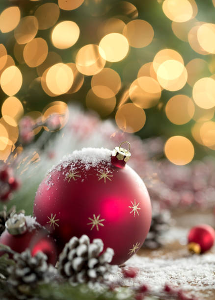 istock Red Christmas Bauble on Christmas Lights Background 1347893487