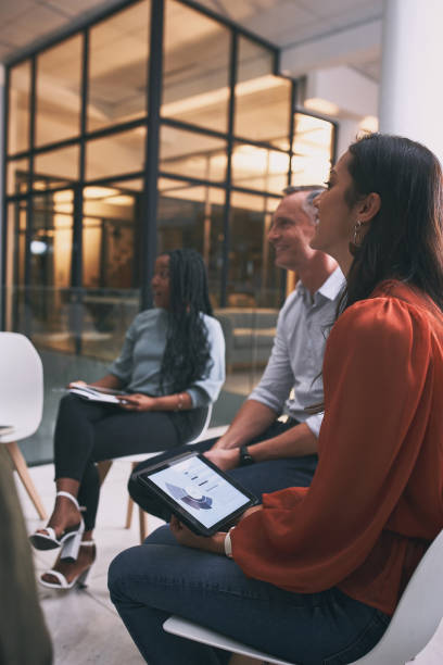 istock Shot of a young woman using a tablet during a team meeting 1347893614