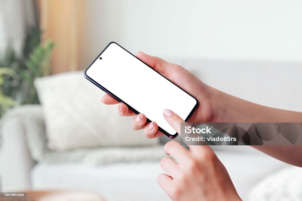 Hand holding smartphone mockup and touching screen Cyborg Stock Photo