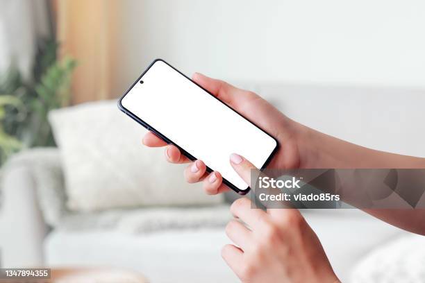 Hand Holding Smartphone Mockup And Touching Screen Stock Photo - Download Image Now - Cyborg, Smart Phone, Template