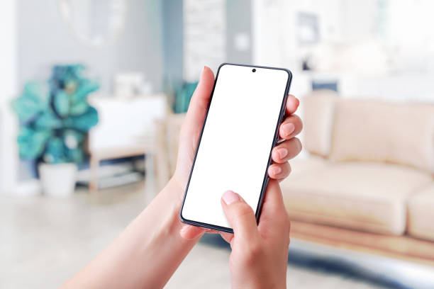 istock Holding phone mockup with finger touchscreen 1347894356