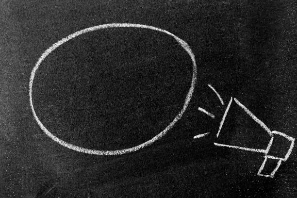 istock White color chalk hand drawing in megaphone with black round bubble banner shape with blank space on blackboard or chalkboard background 1347894734
