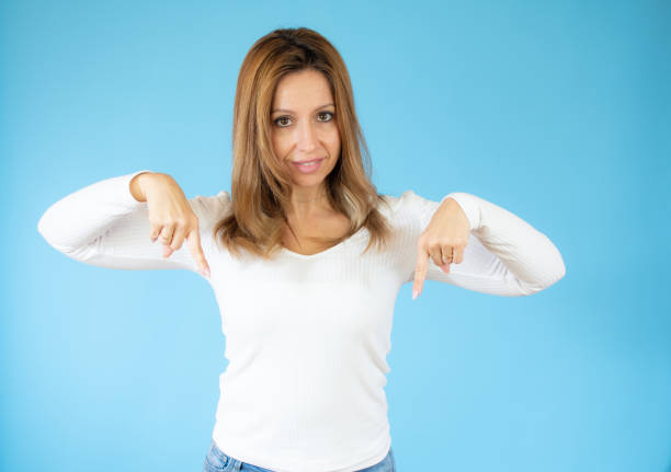 istock Happy young woman presenting with thumbs under over blue background 1347894757