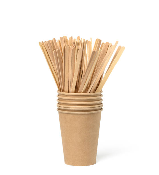 istock wooden sticks for mixing liquid and empty brown paper disposable cups on a white background, concept eco-friendly 1347894945