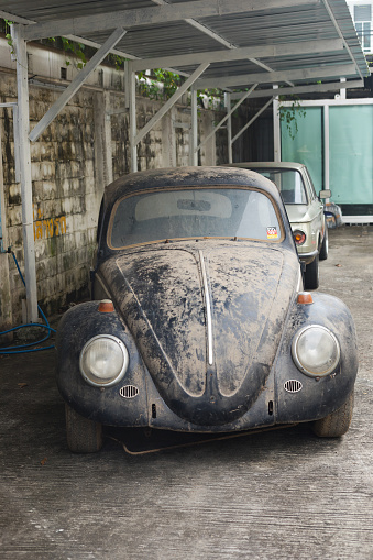 Front view of old grunged VW Beetle oldtimer which is dirty parked in Bangkok Chatuchak