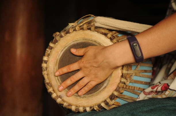 istock Hands holding musical instrument - Indian drum Mridangam 1347895411
