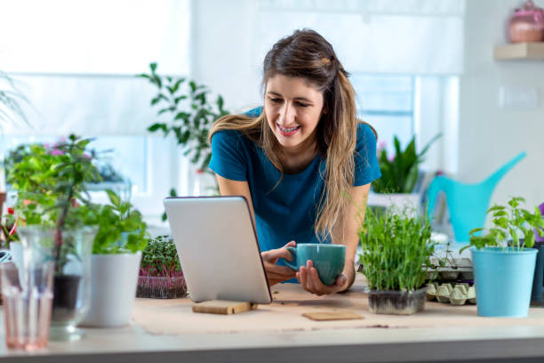 istock Young woman with hearing aid planting micro plants in biodegradable packaging. 1347897558
