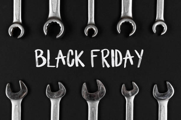 istock Black Friday sign on black background with wrenches 1347898934