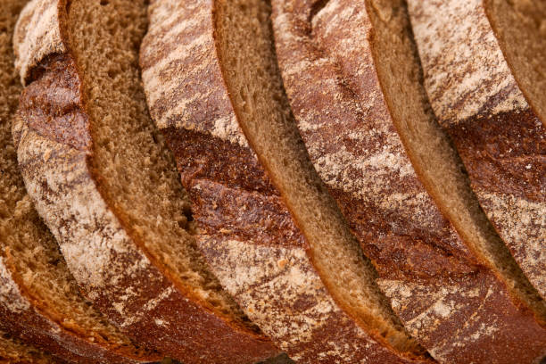 istock Fresh homemade rye bread. Traditional spelled sourdough bread cut into slices on a rustic wooden background. Concept of traditional leavened bread baking methods. Selective focus. 1347902568