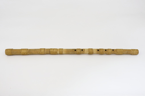 Traditional handmade wooden flute - folk musical instrument that belongs to woodwind group.