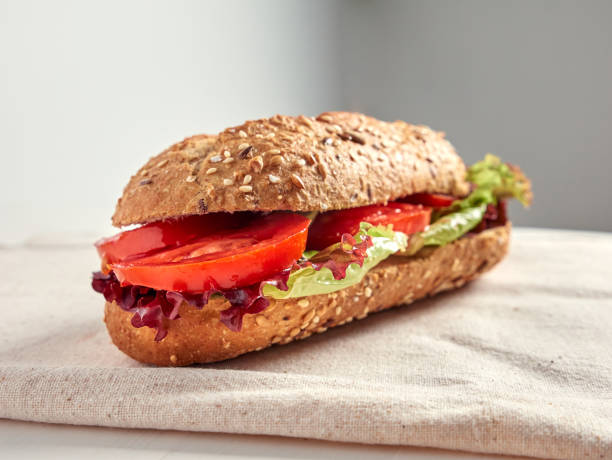 close up look of a tomato and lettuce baguette close up look of a tomato and lettuce baguette, vegetarian food concept Subway Sandwich stock pictures, royalty-free photos & images