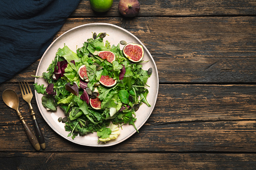 Salad with copy space on wooden dark table