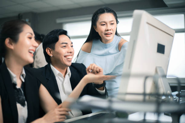 istock Three excited employees reading good news on line in a computer desktop at office 1347906187